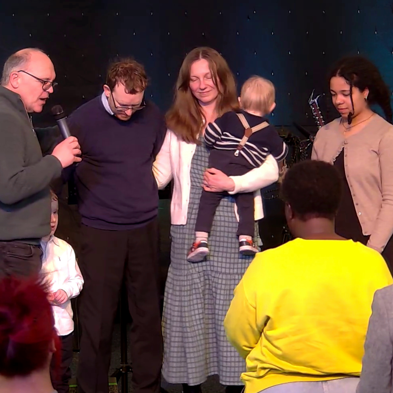 Howard prays with the family